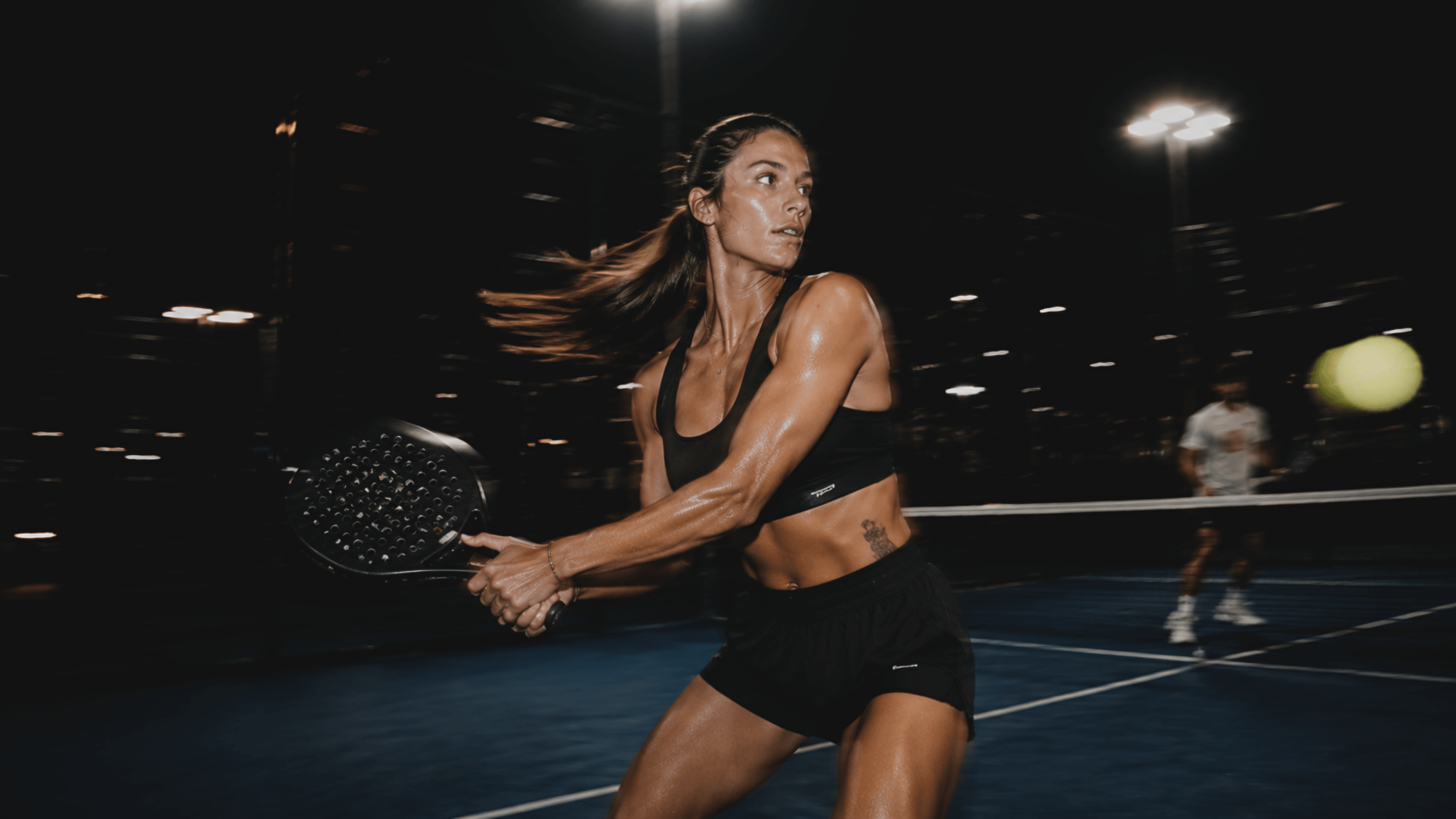 Padel athlete in match play under floodlights